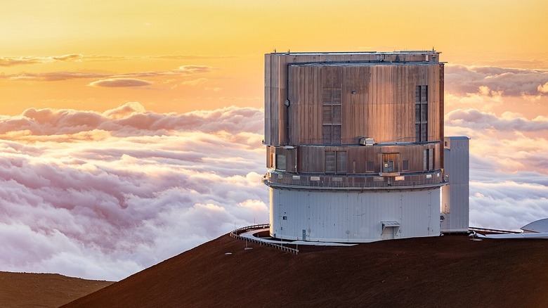 Subaru Telescope at sunset, on its mountaintop above the clouds