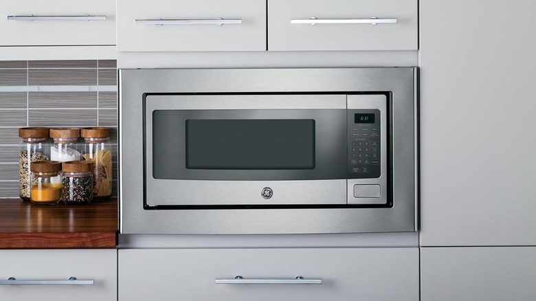 The GE Profile PEM31SFSS microwave oven in a kitchen.