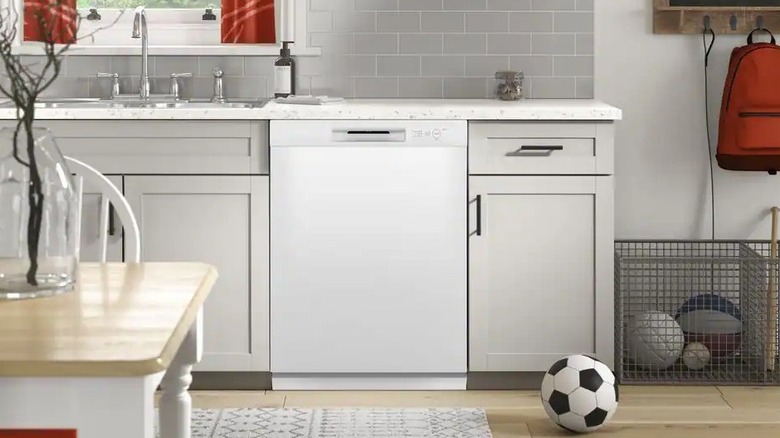 The Hotpoint HDF330PGRWW dishwasher in a kitchen.
