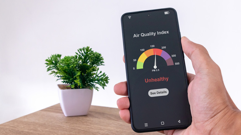 Person checking air-quality index on smartphone