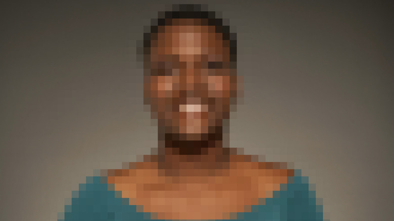 Severely pixelated image of a person.