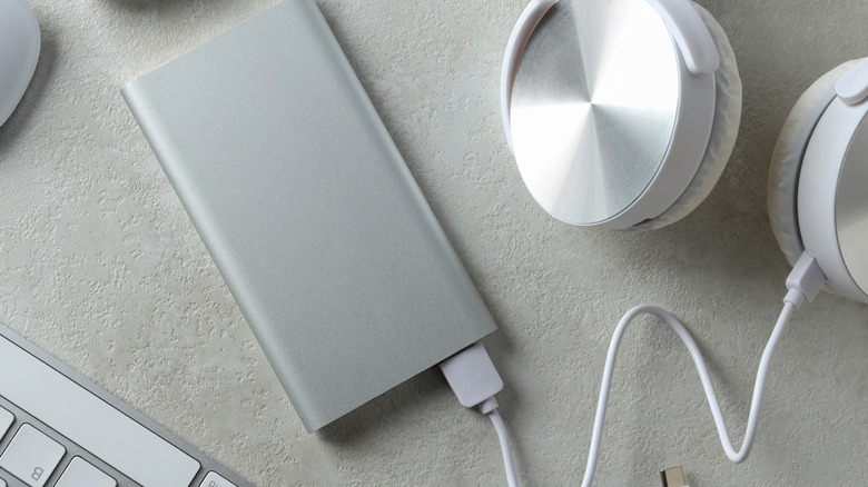 A power bank connected to a pair of headphones.