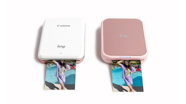 An image of two Canon Ivy 2 Mini printers in Pink and White finishes.