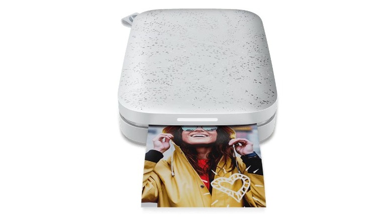 A product render of the 2nd generation HP Sprocket instant printer printing an image.