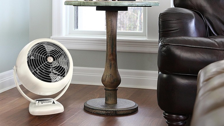 The Vornado VFAN Sr. vintage fan on a wooden floor.