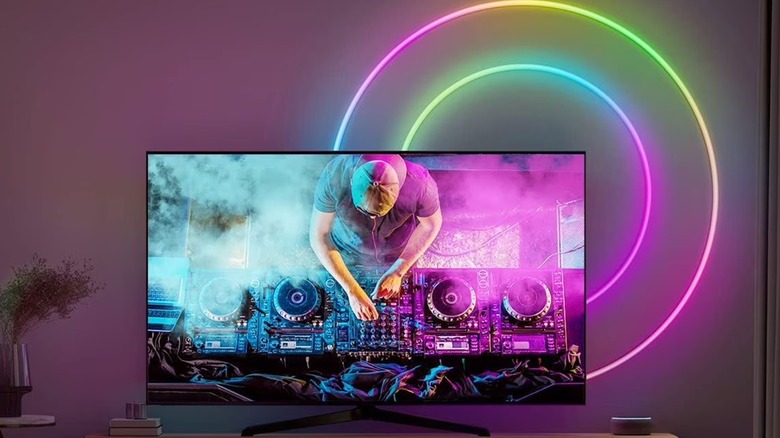 The Govee RGBIC Neon Rope Light smart light installed on a wall behind a TV.