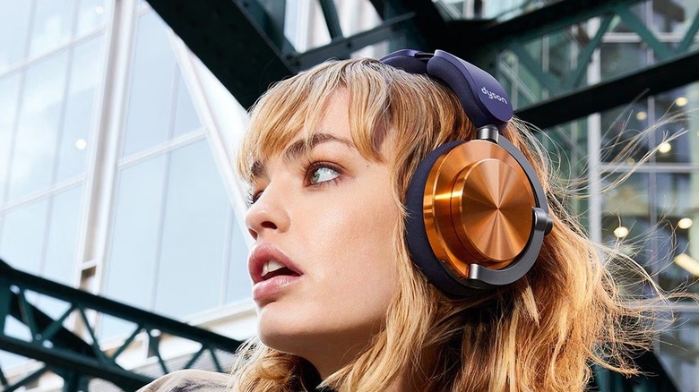 A woman wearing the Dyson OnTrac noise-canceling headphones.