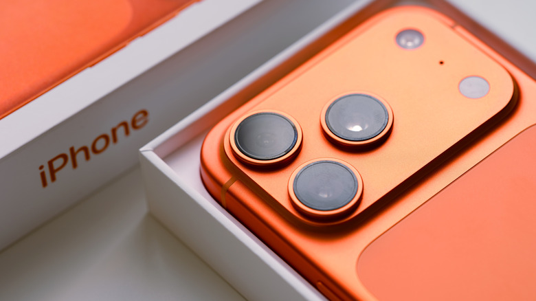 A Cosmic Orange iPhone 17 Pro with packaging.