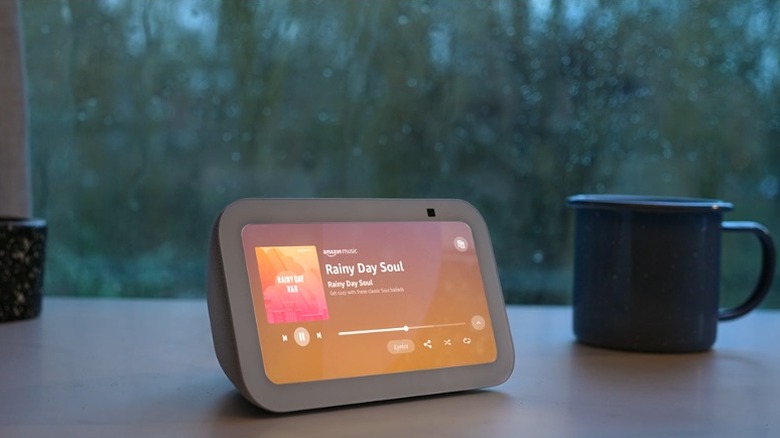 Echo Show 5 placed in front of a window, alongside a mug