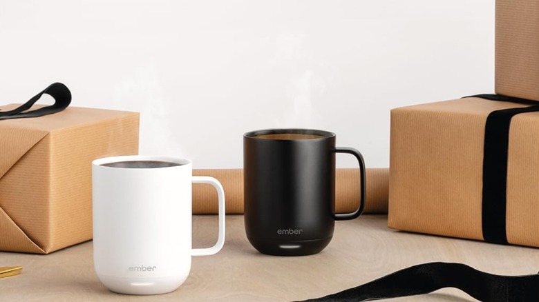 Two smart mugs placed along with wrapped gift boxes