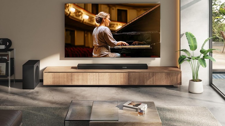 Hisense AX5140Q sat underneath a TV on a wooden desk