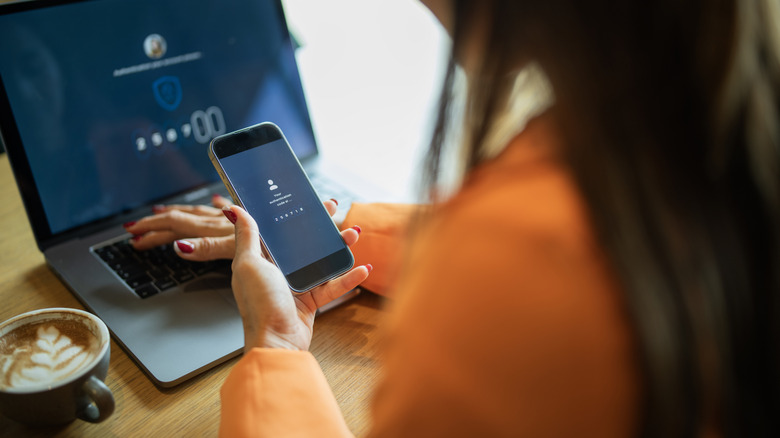 A woman using her smartphone to activate an account and use a password