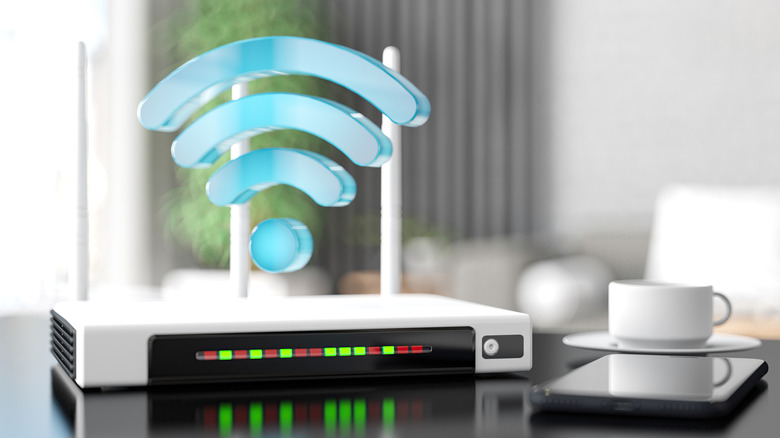 A router on a tablet with a Wi-Fi symbol hovering above it.