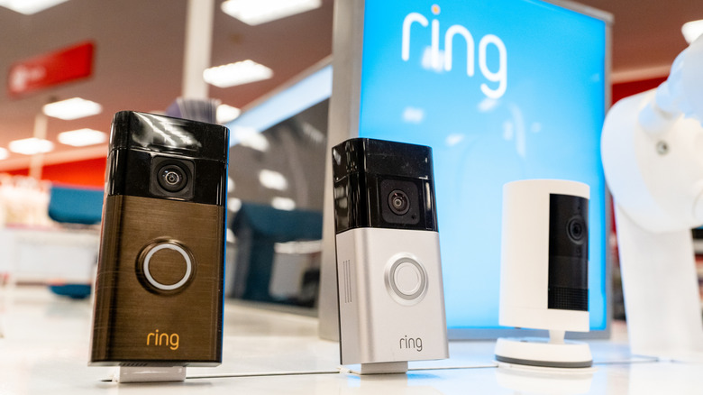 Three Ring camera doorbells showcased on a white table