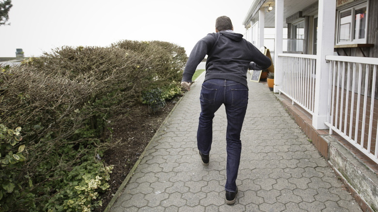A man running right outside a home