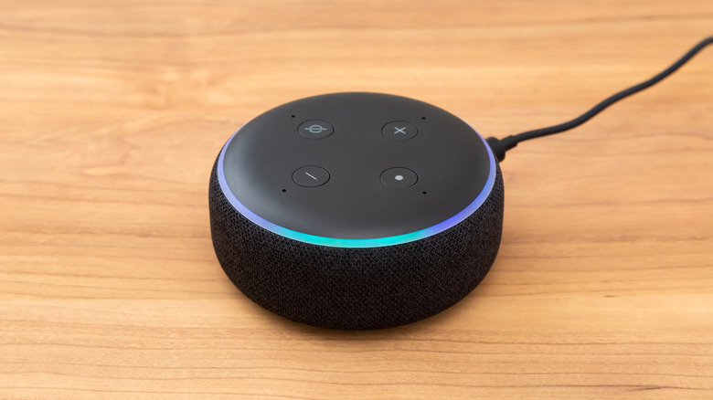 A black Amazon Alexa-enabled device on a wooden countertop.