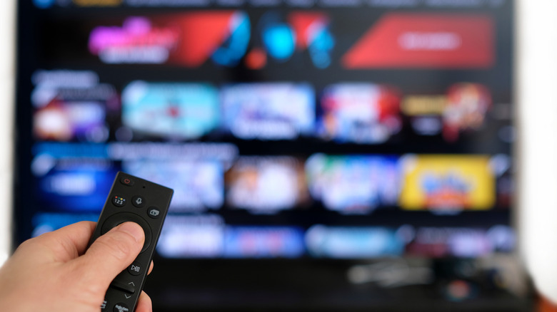 A remote pointed to a TV showing the Prime Video interface.