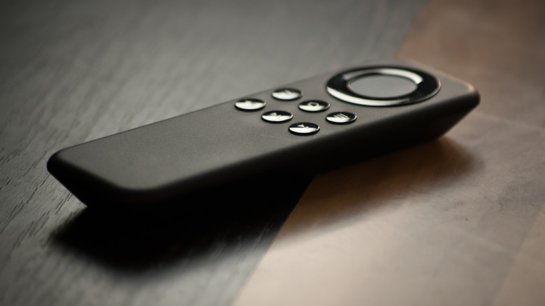 A black remote control on a table.