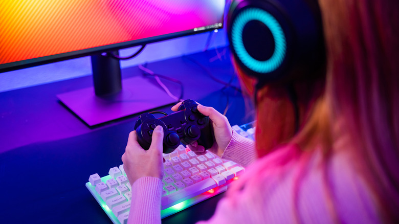 A person holding a controller while looking at a screen