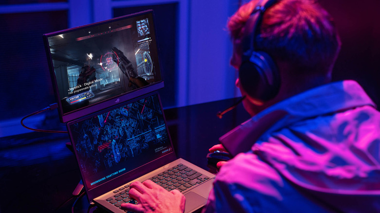 A person gaming using a portable gaming monitor