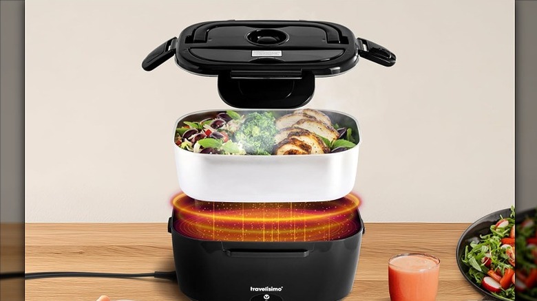 Food placed inside an electric lunch box with a lid on top