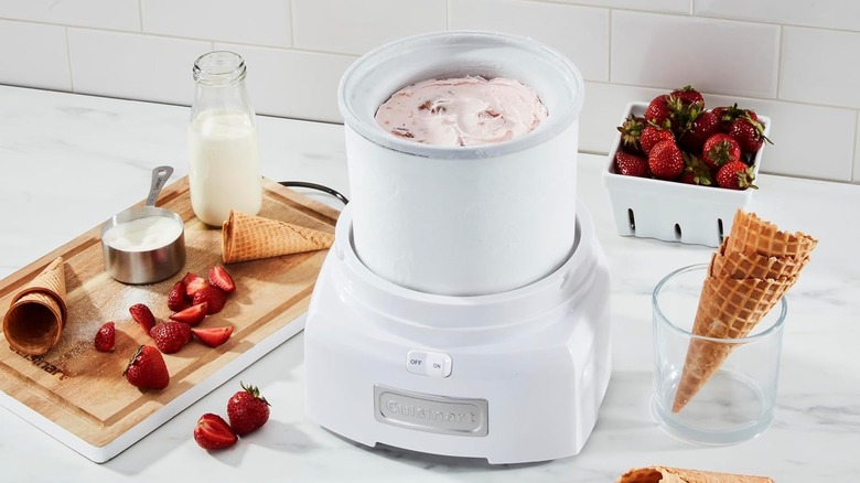 The Cuisinart ICE-21 ice cream maker on a kitchen counter, making strawberry ice cream.