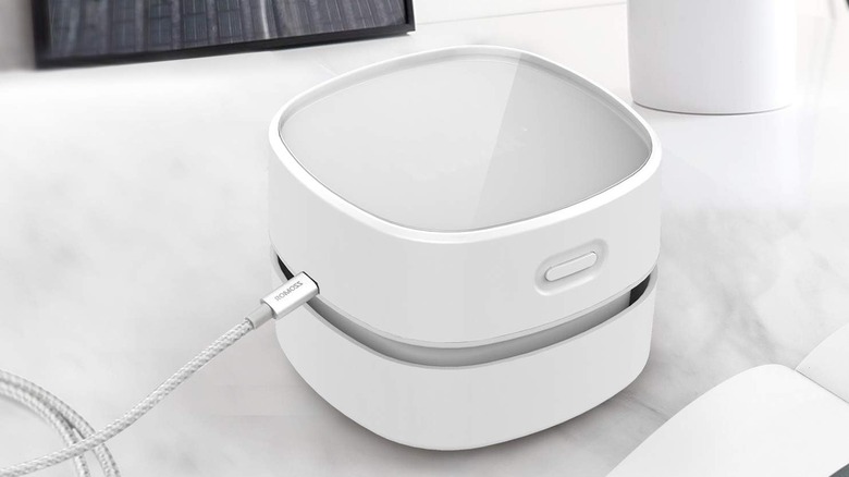 Odistar Desktop Vacuum being charged on its USB cable
