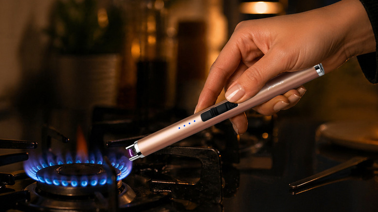 Electric candle lighter being used on a stove top