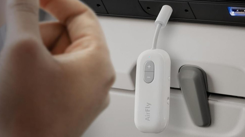 A Twelve South AirFly SE Bluetooth audio transmitter plugged into an airline IFE.