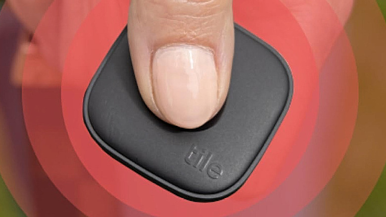 Pressing the emergency SOS button on a Tile by Life360 Mate tracker.