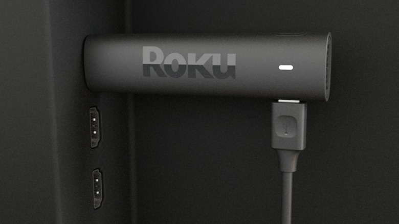 The Roku Streaming Stick 4K plugged into the HDMI port at the back of a TV.