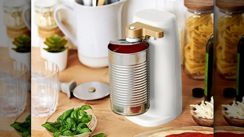 White can opener opening a steel can