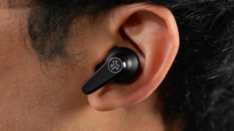 A closeup shot of a JLab earbud in someone's ear