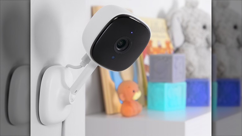 Smart indoor camera mounted on a wall beside some toys