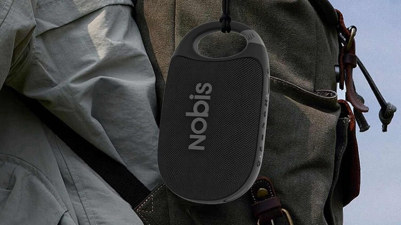 The Nobis Clip N1 attached to a backpack, on a person's back.