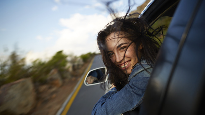 Image of a person looking out of the car window