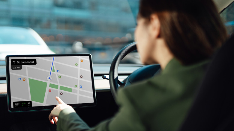 Image of a person using the navigation system on an electric vehicle