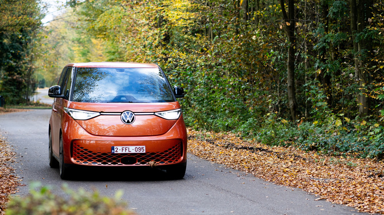 Image of an electric vehicle driving through a forest