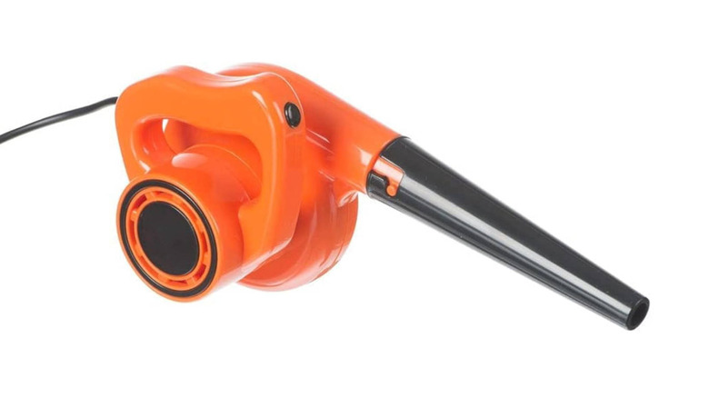 A tiny orange USB-powered leaf blower against a white background