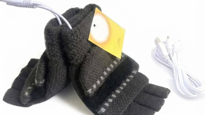 A pair of gray mittens with white USB cables coming out of them