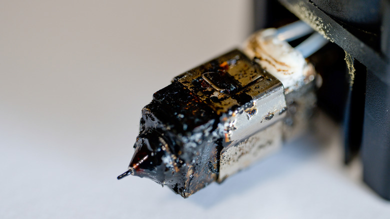 A charred and blackened 3D printer nozzle.