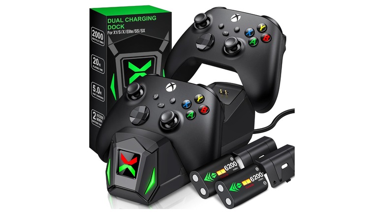 A controller dock next to its box, battery packs, with two controllers.