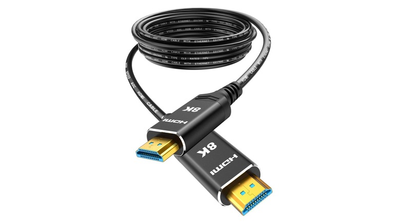 A coiled HDMI cable with "8K" written on it isolated on a white background.