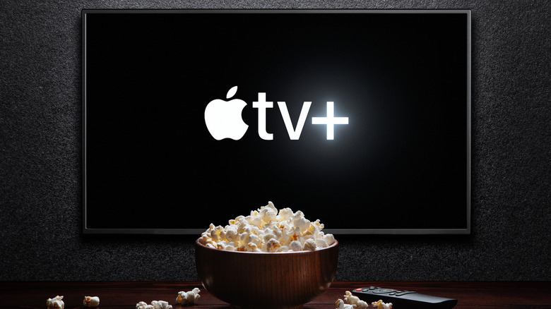 Apple TV+ log on a video screen with popcorn in front of it
