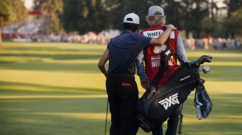 Owen Wilson as Pryce Cahill and Peter Dager as Santi in a golf tournament