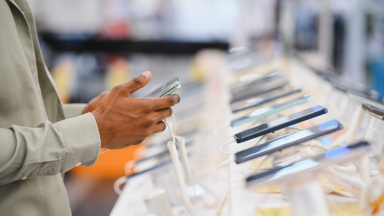 Man shopping for a phone in a retail shop