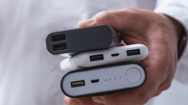 various power banks in a man's hand
