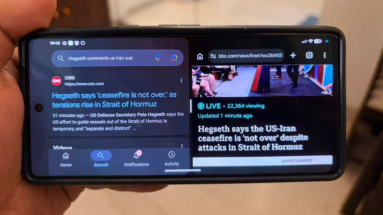 A phone in split-screen mode, showing the US-Iran news on both halves of the screen
