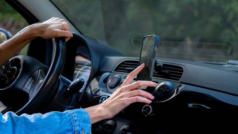Driving and using a phone placed on a stand that's fixed to the dashboard