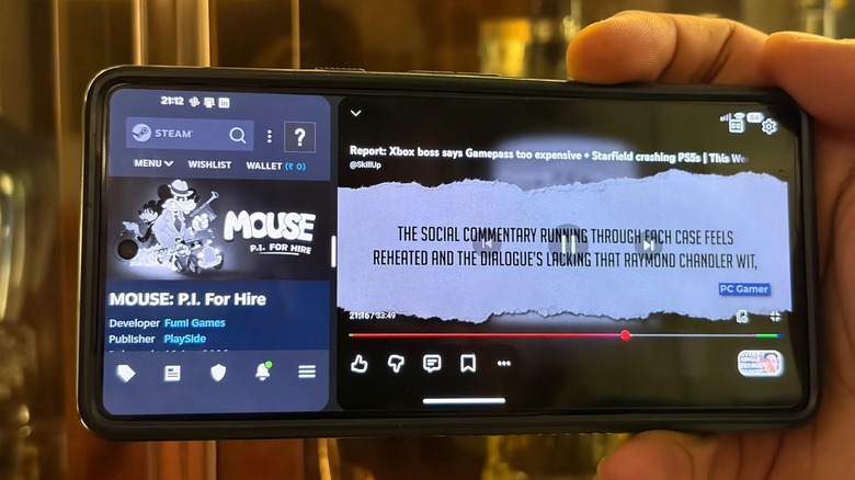 A phone in split-screen mode, showing a YouTube video on the larger side and a list of games on the smaller side